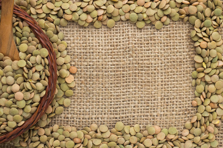 green lentils on jute as backgroundの写真素材