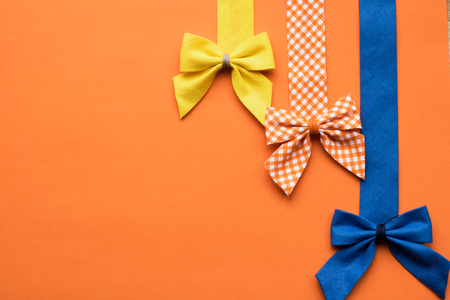 Bows of textiles on an orange background - copy spaceの写真素材