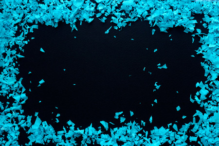 Confeti - frame of blue confetti on a black backgroundの写真素材