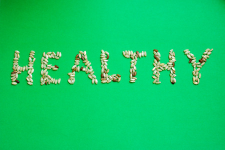 Rice in the form of word "healthy" on a green backgroundの写真素材