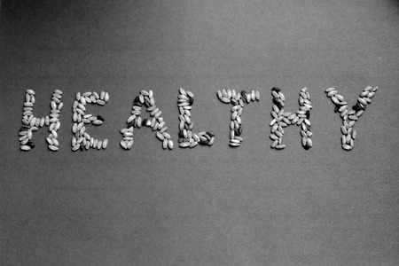 Letters of rice - word "healthy"- gray backgroundの写真素材
