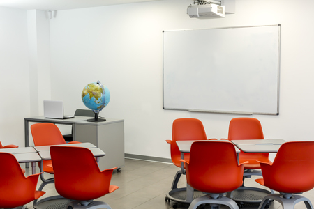 Modern classroom interior, with white board and movable tables and chairs.の写真素材