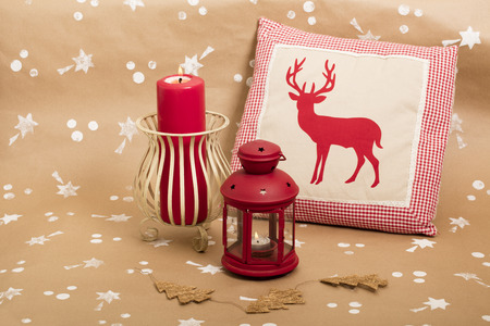 Christmas holiday composition, with candles and cushion with deer design.の写真素材