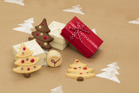 Christmas composition â gift boxes and Christmas chocolates on handmade background.の写真素材