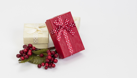 Christmas composition â white and red gift boxes, mistletoe berries on white background.の写真素材