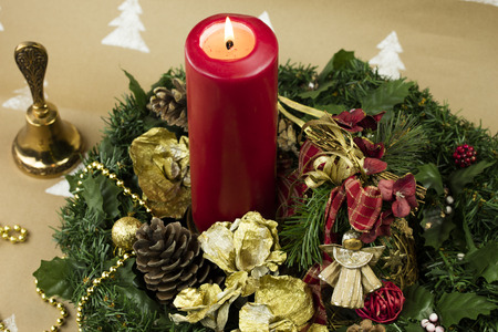 Christmas composition with yule wreath, golden ornaments and red candle.の写真素材