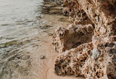 Rock with stones on the coast of the beach.の写真素材