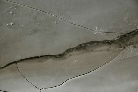 Texture of ice on the river, broken into cracks,の写真素材