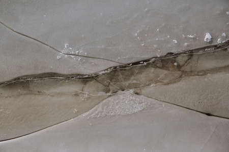 Texture of ice on the river, broken into cracks,の写真素材