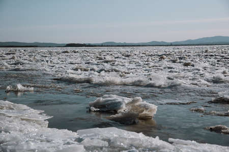 Texture of ice on the river, broken into cracks,の写真素材