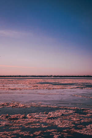 Sunset on the river, ice on the backgroundの写真素材