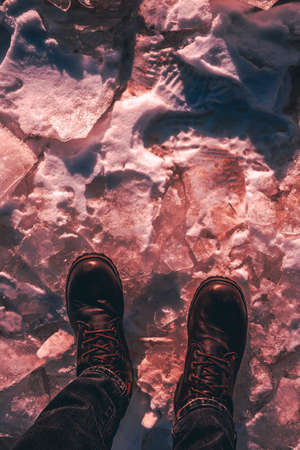 Boots on the ice, the traveler, sunset, the ice was redの写真素材