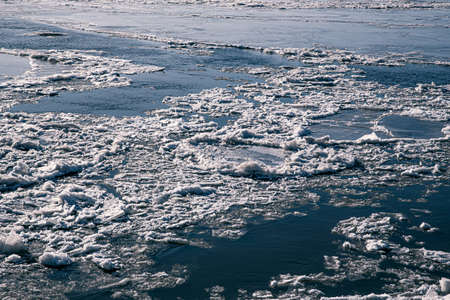 Texture of ice on the river, broken into cracks,の写真素材