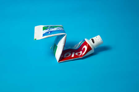 Colgate toothpaste, pumping the press. Funny and minimal color still life photographyのeditorial素材
