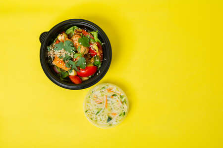 Fast food Chinese, chicken vegetable salad. On yellow backgroundの写真素材