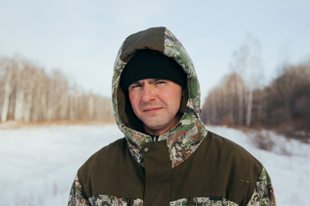A logger saws a tree in the forest in winter, in Russia for firewoodの写真素材