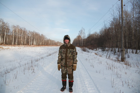 A logger saws a tree in the forest in winter, in Russia for firewoodの写真素材