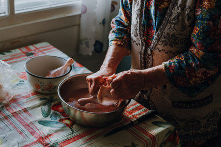 Russian granny butchering a chicken with her bare handsの写真素材