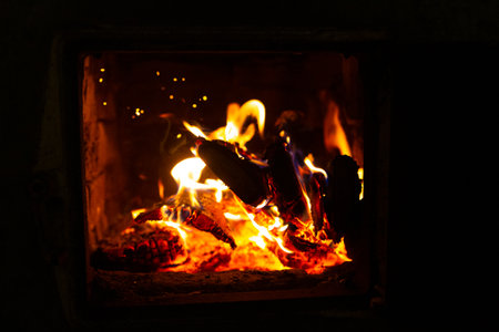 Fire in the stove, wood, sparks, on a black backgroundの写真素材