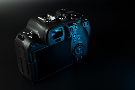 Canon r6 digital camera close-up, black background, glare