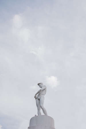White sculpture on the background of a blue sky with cloudsの写真素材
