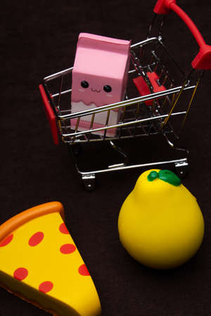 Toy plastic fruits and food isolated on black backgound. Toys for children's kitchenの写真素材