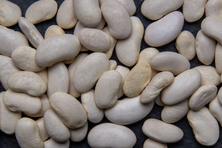 Natural white bean closeup on black background.の写真素材