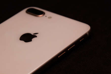 Saint-Petersburg-18 August, 2020: Front and back view of iPhone 8 Plus Gold smartphone. Iphone on black backgroundのeditorial素材