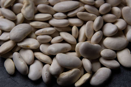 Natural white bean closeup on black background.の写真素材
