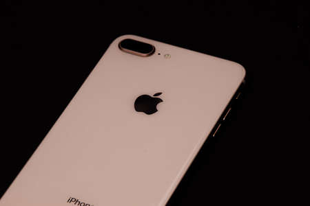 Saint-Petersburg-18 August, 2020: Front and back view of iPhone 8 Plus Gold smartphone. Iphone on black backgroundのeditorial素材