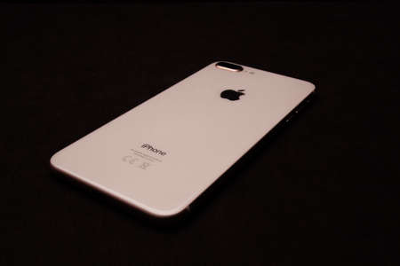 Saint-Petersburg-18 August, 2020: Front and back view of iPhone 8 Plus Gold smartphone. Iphone on black backgroundのeditorial素材