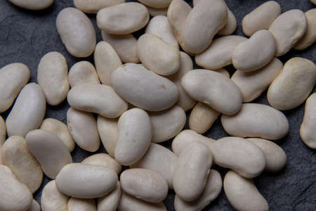 Natural white bean closeup on black background.の写真素材