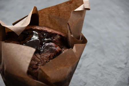Photo of chocolate muffin on a dark stone boardの写真素材