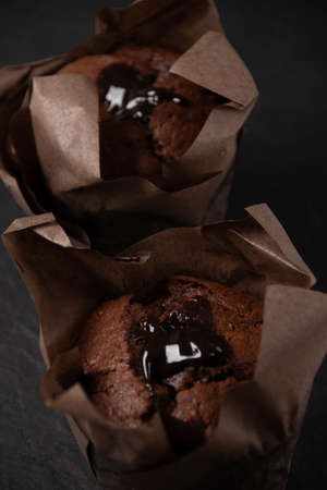 Photo of chocolate muffin on a dark stone boardの写真素材