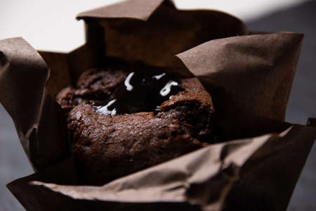Photo of chocolate muffin on a dark stone boardの写真素材