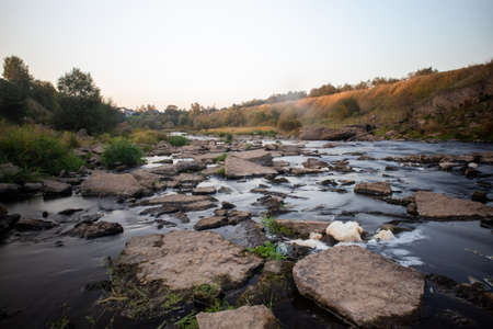 A photo of a small river in Russia, taken on a long exposure. Stone Shore. Beautiful landscape
