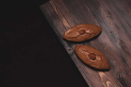 Delicious almond cookies on a wooden background
