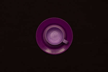 Purple tea set on a dark background. Plastic toyの写真素材