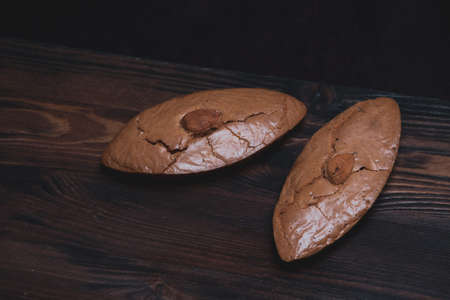 Delicious almond cookies on a wooden backgroundの写真素材