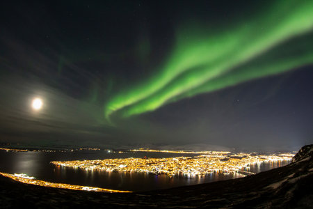 Bright northern lights above TromsÃ¸ city, Norwayの写真素材