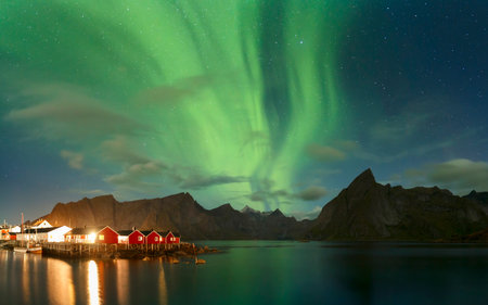 Strong Northern Lights over the Village of HamnÃ¸y, Lofoten Islands, Norwayの写真素材