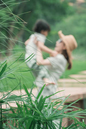 Chinese family playing outdoors, mother and daughter playing in Luhu Lake in Chengdu, Sichuanの写真素材