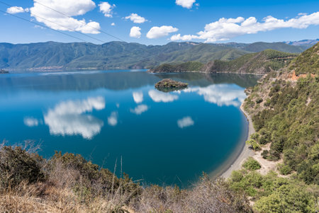 Blue sky and white clouds reflected on the surface of Lugu Lakeの写真素材