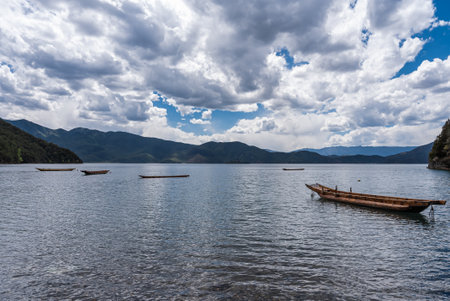 Pig trough boats on the surface of Lugu Lake in Chinaの写真素材