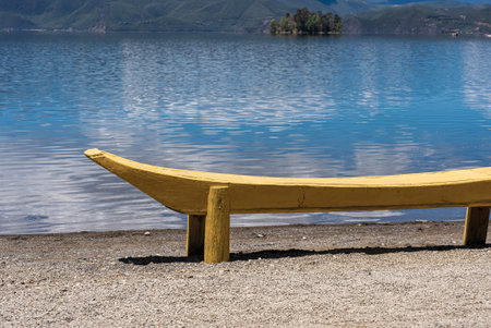 The reflection of blue sky and white clouds on the water surface of Lugu Lake in Chinaの写真素材