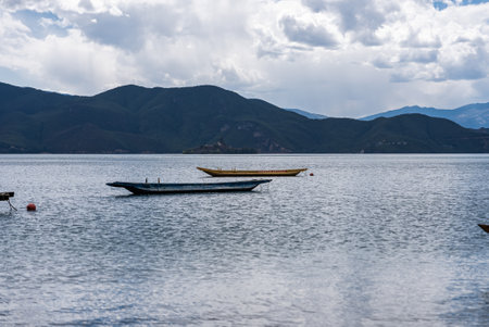 Pig trough boats on the surface of Lugu Lake in Chinaの写真素材
