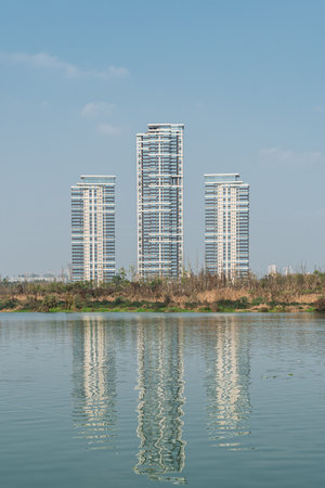 Reflection of high-rise buildings by the lakeの写真素材