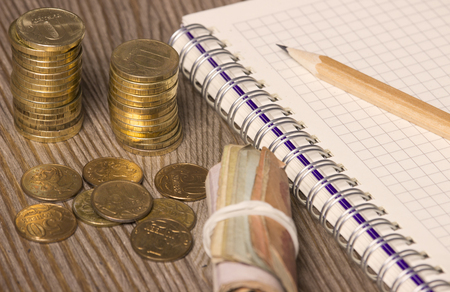 coins, notebook and penの写真素材