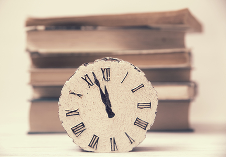 clock and stack of booksの写真素材