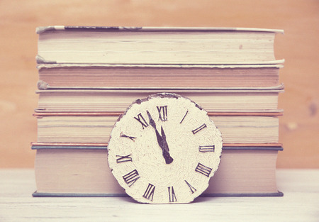 clock and stack of booksの写真素材